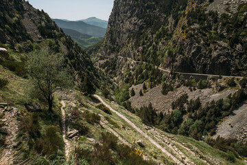 Fototapeta na wymiar Panoramic view of a mountain gorge in the Vall de Nuria natural reserve in Spain, with trails for hiking in the mountains. A place where you can relax from the hustle and bustle of the city.