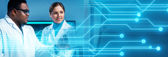 Group of microelectronic engineers discussing in a modern microprocessor manufacture lab. Workplace...