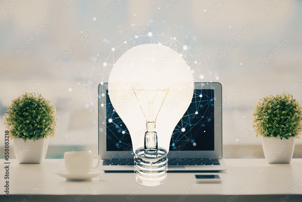 Poster computer on desktop in office with bulb icon hologram. double exposure. concept of idea.