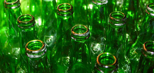 Green glass empty beer bottle open top closeup