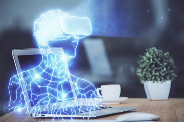 Obraz premium Computer on desktop with AR theme icon. Multi exposure. Concept of augmented reality.