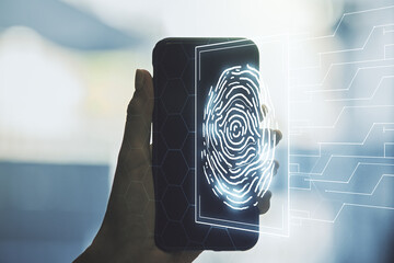 Double exposure of abstract creative fingerprint hologram and hand with cell phone on background,...