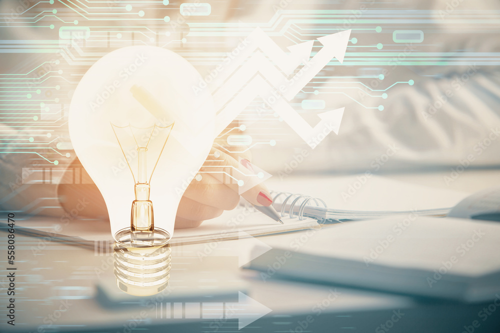 Poster bulb hologram over hands taking notes background. concept of idea. double exposure