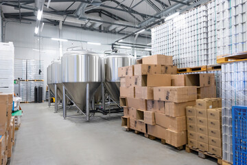Interior of a brewery with canned beverages ready for shipping