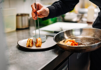 man chef cooking fried shrimp on kitchen