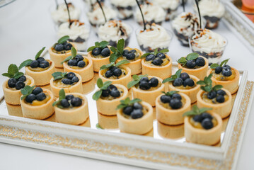 Dessert on the table. Wedding desserts. Wedding table. Serving. Cakes. Fruits. Food