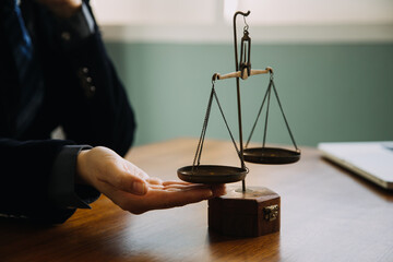 Business and lawyers discussing contract papers with brass scale on desk in office. Law, legal...