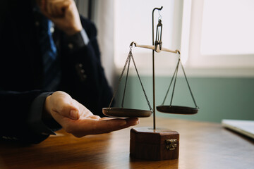 Business and lawyers discussing contract papers with brass scale on desk in office. Law, legal...