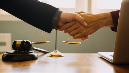 Business and lawyers discussing contract papers with brass scale on desk in office. Law, legal services, advice, justice and law concept picture with film grain effect