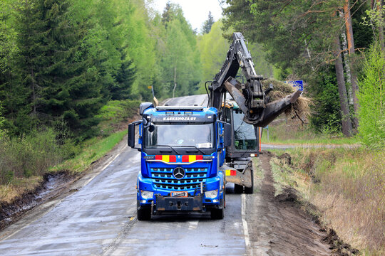 Blue Mercedes-Benz Arocs Tipper Truck and Excavator Clearing Ditches.