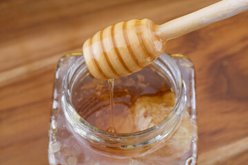 selective focus Honey on wooden honey dipper close up