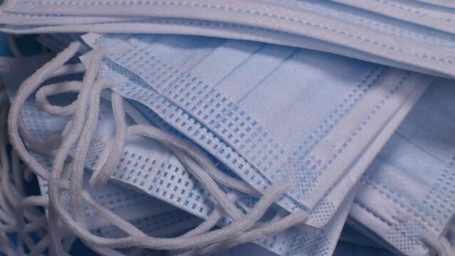 stack of medical protective face masks rotates. The concept of protection from viruses, infections