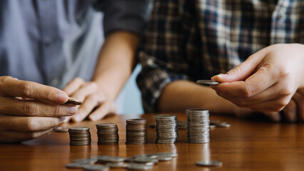 businessman holding coins putting in glass with using calculator to calculate concept saving money for finance accounting, Business, finance, investment, Financial planning.