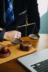 Business and lawyers discussing contract papers with brass scale on desk in office. Law, legal...