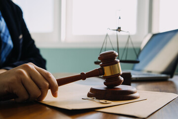 Business and lawyers discussing contract papers with brass scale on desk in office. Law, legal...