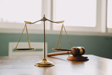Business and lawyers discussing contract papers with brass scale on desk in office. Law, legal...