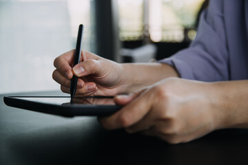 Asian colleagues man and woman discussing and working with laptop computer on office desk in the office