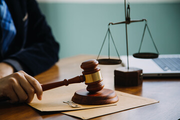 Business and lawyers discussing contract papers with brass scale on desk in office. Law, legal services, advice, justice and law concept picture with film grain effect