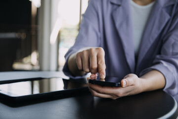 Asian colleagues man and woman discussing and working with laptop computer on office desk in the office