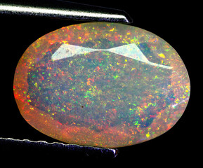 Natural beautiful gemstone opal on gray background