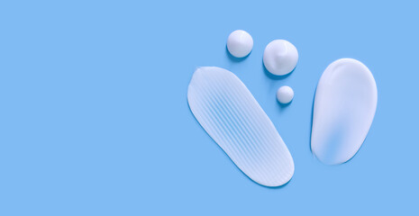 cosmetic smears cream texture on blue background