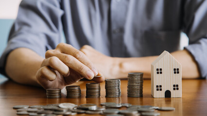 businessman holding coins putting in glass with using calculator to calculate concept saving money for finance accounting, Business, finance, investment, Financial planning.
