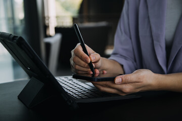 Asian colleagues man and woman discussing and working with laptop computer on office desk in the office