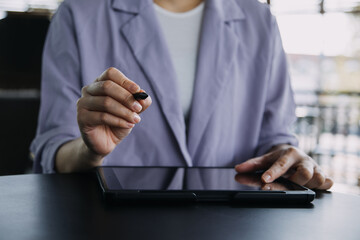 Asian colleagues man and woman discussing and working with laptop computer on office desk in the office