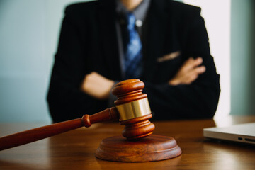 Business and lawyers discussing contract papers with brass scale on desk in office. Law, legal services, advice, justice and law concept picture with film grain effect