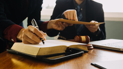 Business and lawyers discussing contract papers with brass scale on desk in office. Law, legal...