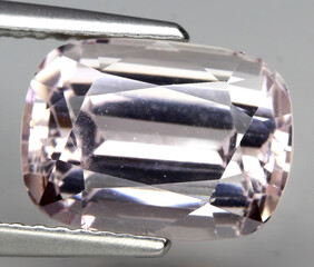 Natural beautiful gemstone kunzite on gray background