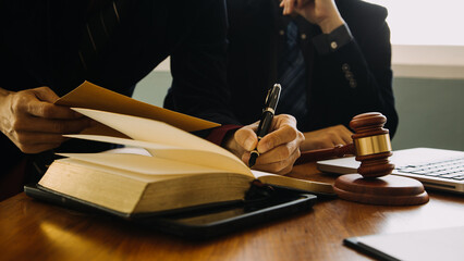 Business and lawyers discussing contract papers with brass scale on desk in office. Law, legal...