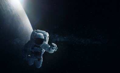 Astronaut and Earth. Elements of this image furnished by NASA.