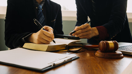 Business and lawyers discussing contract papers with brass scale on desk in office. Law, legal...