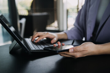 Asian colleagues man and woman discussing and working with laptop computer on office desk in the office