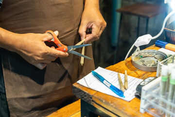 Person preparing cannabis cigarette in a store in Thailand where recreation cannabis is legal