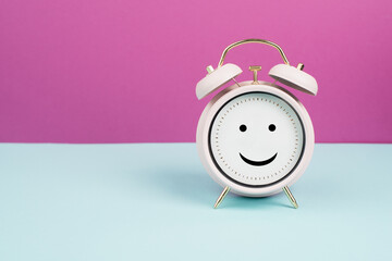 Happy  face on an alarm clock, mental health concept, positive  emotion and mindset
