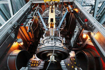 Perform a lift to install a new turbine engine for a power plant © Alexander