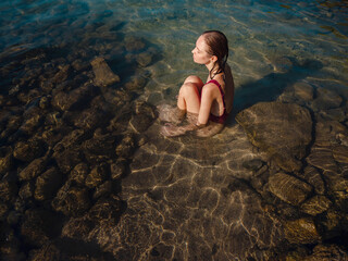 female tourist wearing swimsuit relaxing in sea at beach near ancient city Phaselis, Kemer Antalya...