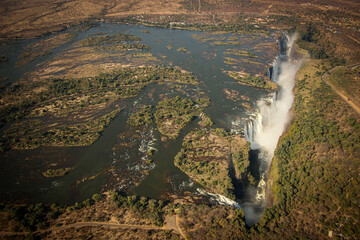 Huge waterfall drops into a gorge - aerial photo