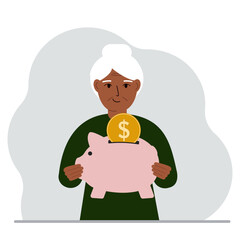 Happy old woman holds a piggy bank, a coin falls into the piggy bank. The concept of saving finance, savings, investing finances.