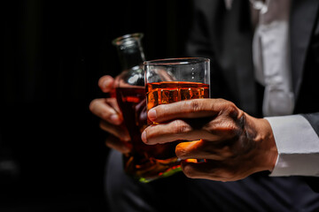 Closeup businessmen holding a glass of whiskey