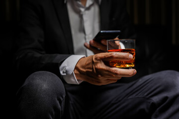 Closeup businessmen holding a glass of whiskey