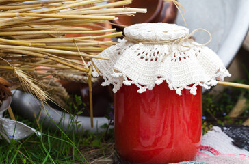 Rustic food concept. Natural tomato juice in a glass jar on country fair