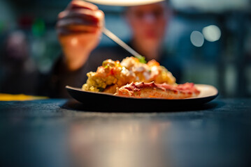 chef decorated plate with food on kitchen