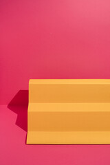 Yellow paper podium on magenta background. Minimal concept.