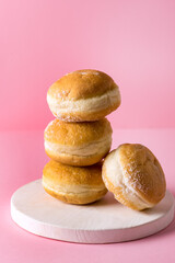 Stack of Traditional German Polish Donut with Berry Jam Dusted with Sugar The traditional Meal Pink Background Vertical