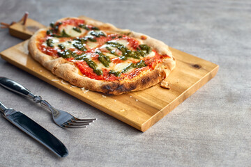 Fresh baked focaccia or pizza with mozzarella and pesto.