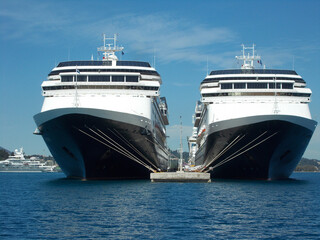 Two blue luxurious holiday vacation ocean cruise liner ships in port