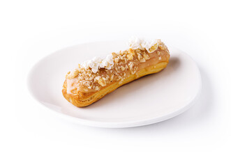 Caramel eclair on white plate isolated